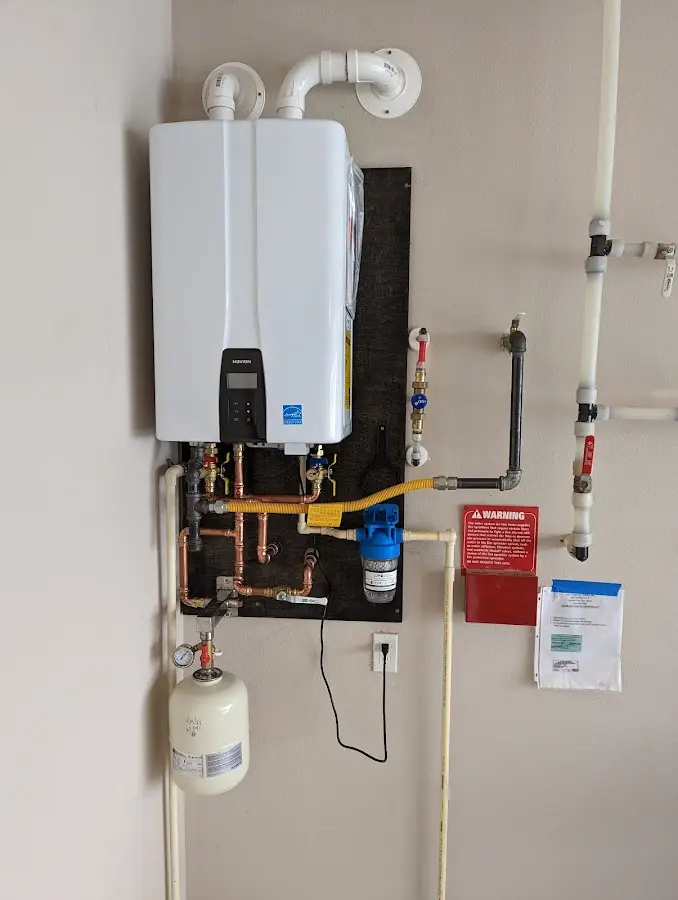 Professional plumber installing copper piping in a Crofton home